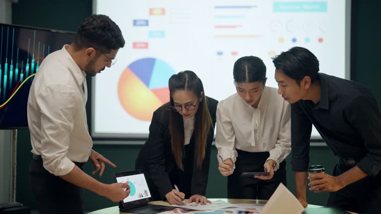 The investor team analyses data statistics to manage marketing plans together.